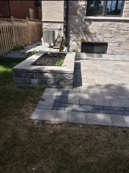 Raised stone garden bed and patio with defined edges